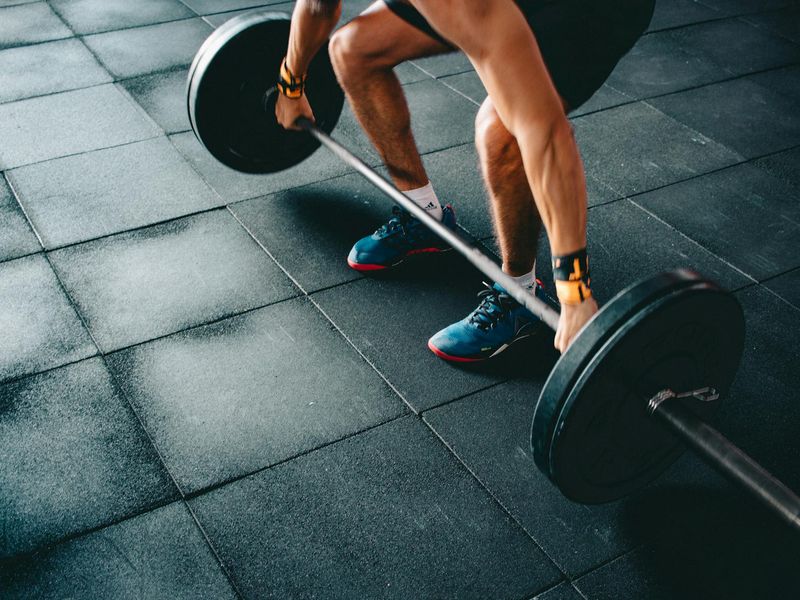 Man focusing on his grip before a heavy deadlift attempt